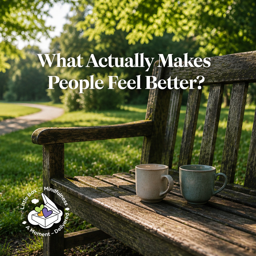 Two mugs on a wooden bench in a summer park, representing connection, support and meaningful conversation.