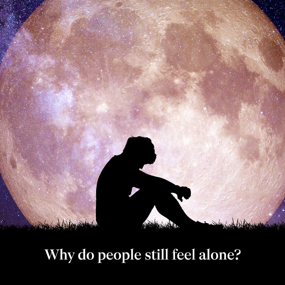 Person sitting alone under a large moon representing loneliness and mental health, with text “Why do people still feel alone?”
