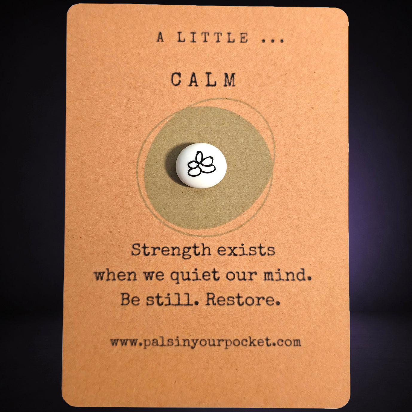 "A Little Calm” mindfulness card with a small white meditation pebble, featuring the message: “Strength exists when we quiet our mind. Be still. Restore."