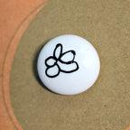 A Little Calm mindfulness pebble with meditation symbol on affirmation card about quieting the mind and restoring calm.