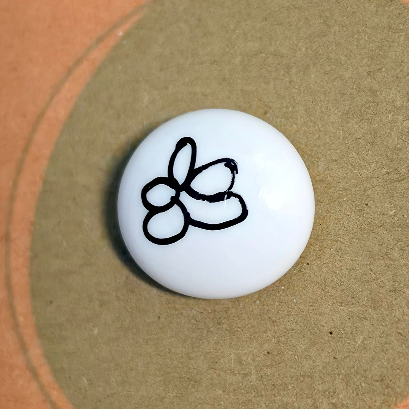 A Little Calm mindfulness pebble with meditation symbol on affirmation card about quieting the mind and restoring calm.