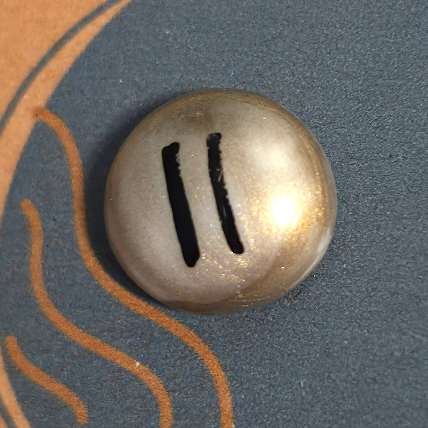 Close-up of Pause mindfulness pebble on calming affirmation card about slowing down and breathing deeply.