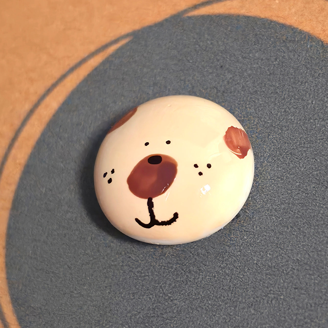 Close-up of Bear Hug mindfulness pebble with bear face on supportive affirmation card about love and reassurance.