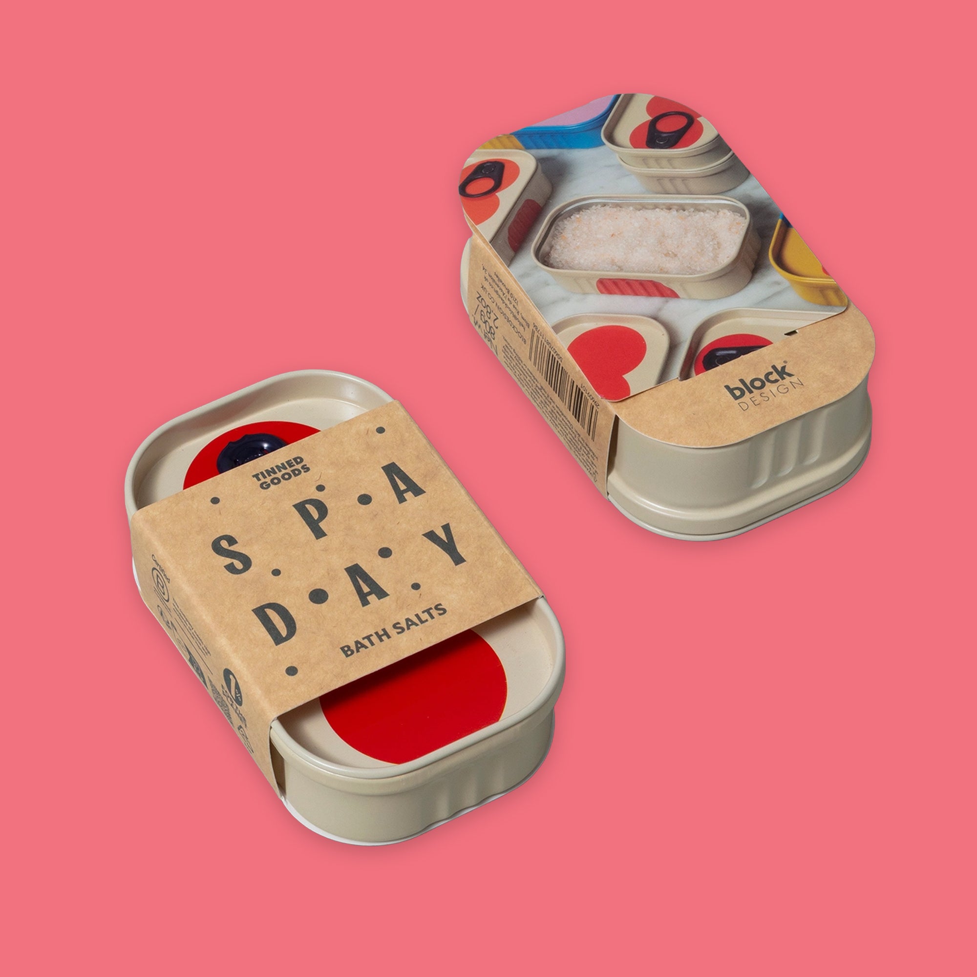 One sardine metal tins showing top and bottom of Bath Salts by Block Party on a solid pink background. Kraft paper band wrapped around it that reads 'SPAY DAY BATH SALTS'.