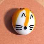 Close-up of Fox Sake mindfulness pebble with smiling fox face on humorous affirmation card.