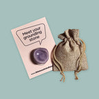 Purple worry stone with hessian pouch and grounding stone card for mindfulness and anxiety relief