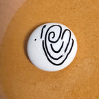 Close-up of Here For You mindfulness pebble with supportive affirmation card about being there no matter how long it takes.