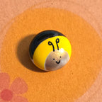 Close-up of Bee mindfulness pebble on supportive card sending love and letting someone know they are on your mind.