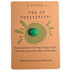 A Little Pea of Positivity mindfulness pebble with smiling green pea on uplifting affirmation card.
