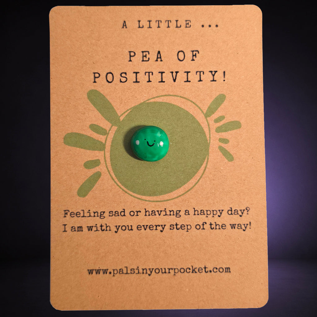 A Little Pea of Positivity mindfulness pebble with smiling green pea on uplifting affirmation card.