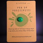 A Little Pea of Positivity mindfulness pebble with smiling green pea on uplifting affirmation card.