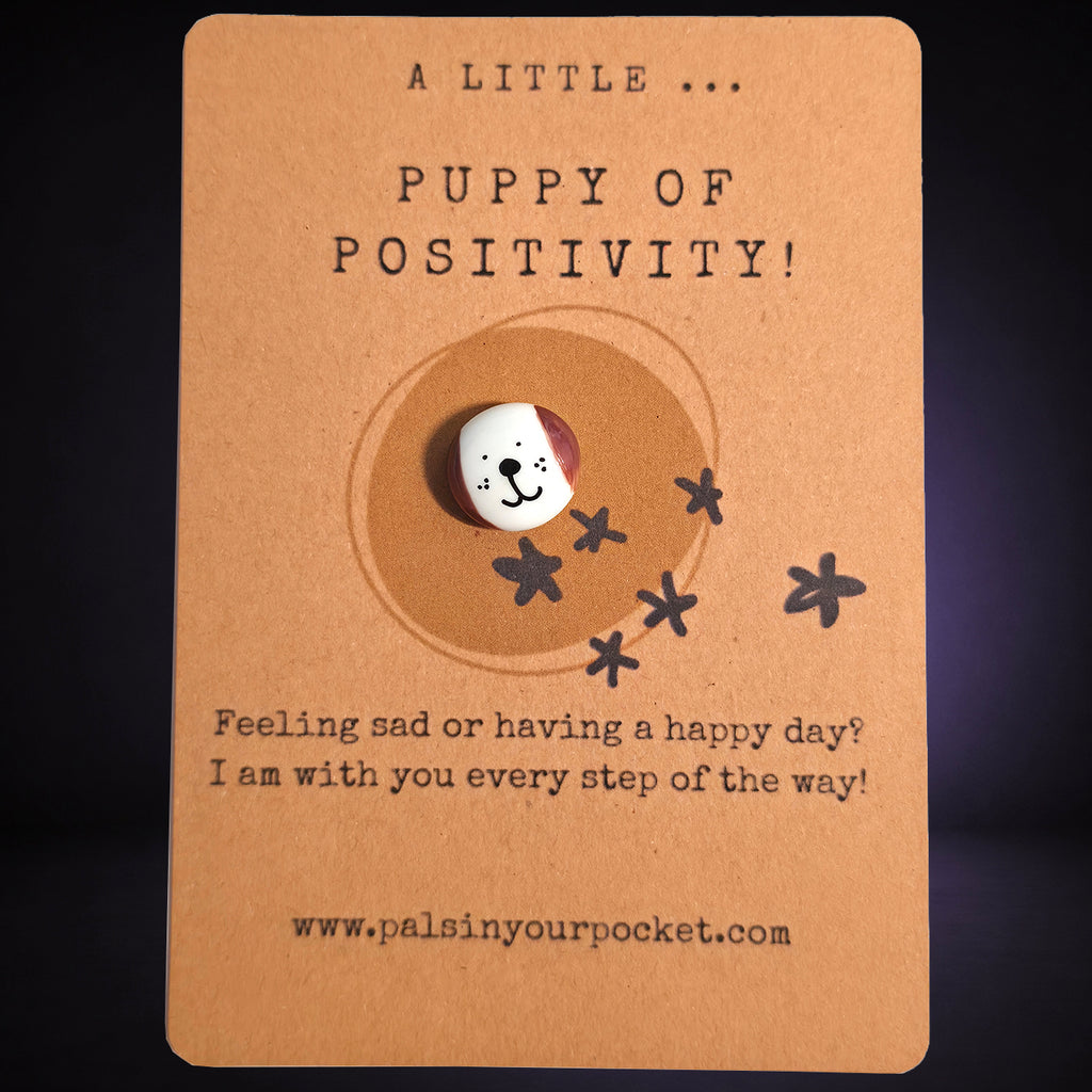 A Little Puppy of Positivity mindfulness pebble with cute dog face on affirmation card offering encouragement and support.