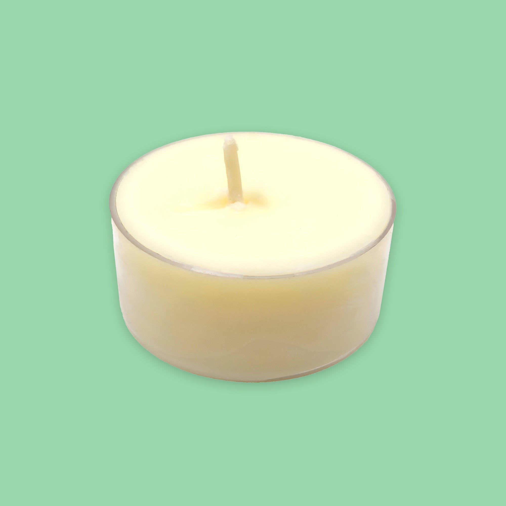 A single cream-coloured soy tea light candle in a clear plastic holder, centred against a solid mint green background.