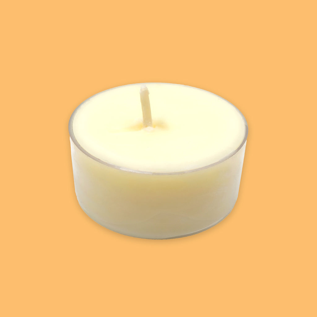 A single soy tea light candle in a clear holder, centred on a solid orange background.