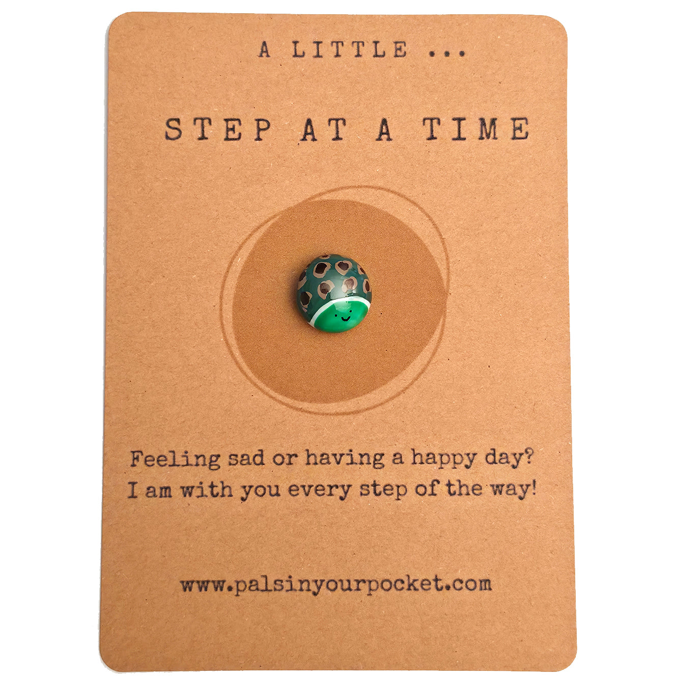 A Little Step at a Time mindfulness pebble with smiling turtle on encouraging affirmation card.
