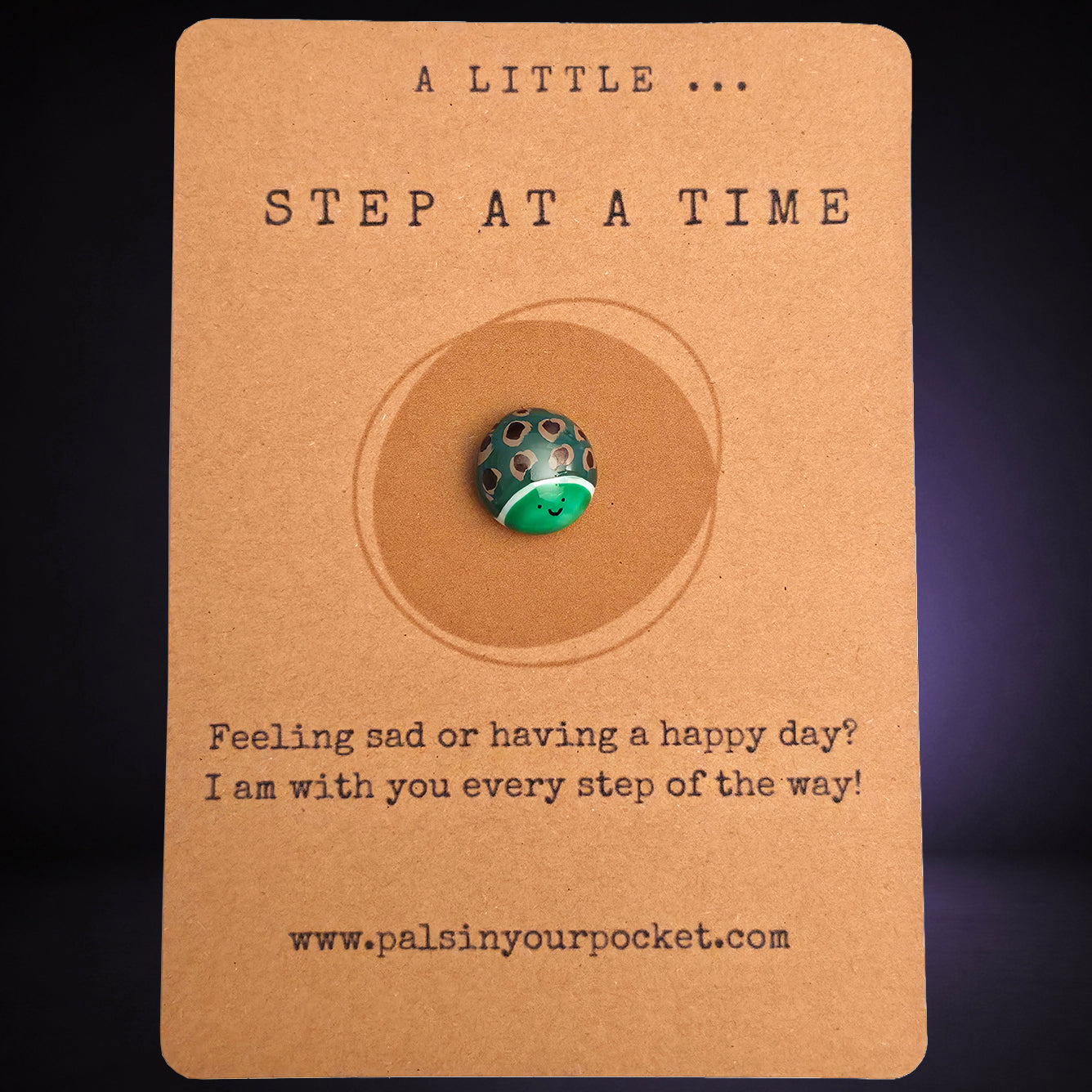 A Little Step at a Time mindfulness pebble with smiling turtle on encouraging affirmation card.