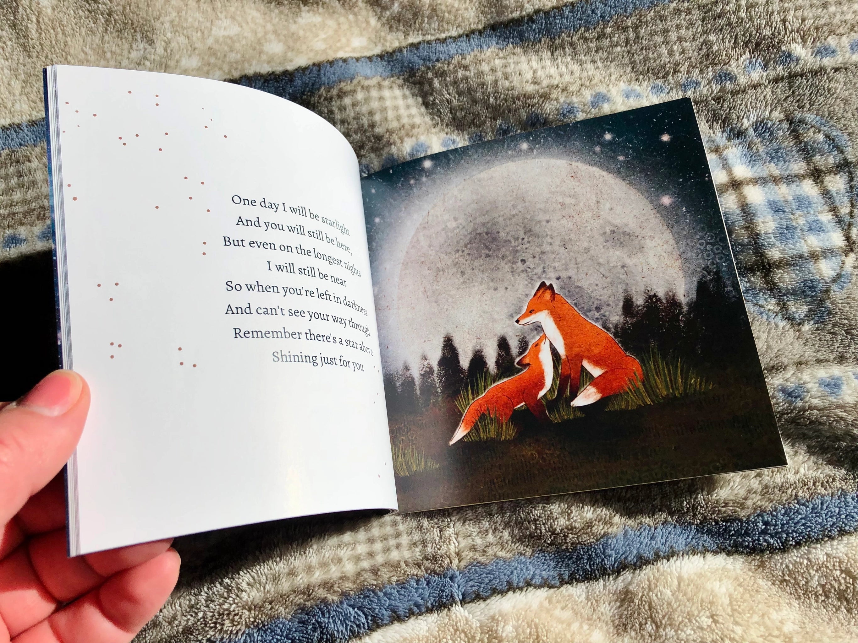 Open book with a fox illustration on a textured fabric background