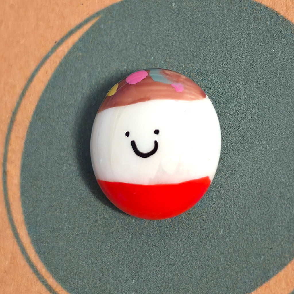 Close-up of You're Fab mindfulness pebble with cheerful face on positive affirmation card celebrating confidence and encouragement.